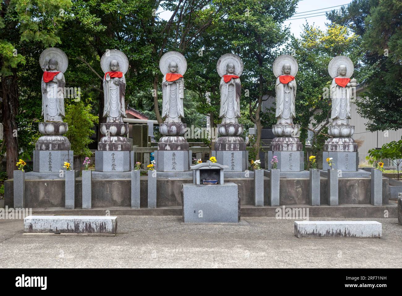 Stone statues (public art) of Ojizou san, with red bibs. Kanazawa, Japan. TRANSLATION leftto