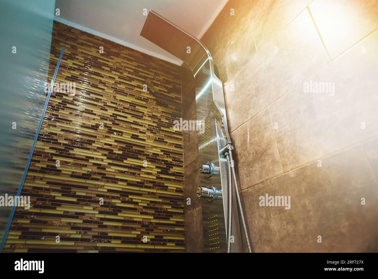 Modern shower panel in tiled bathroom. Stock Photo