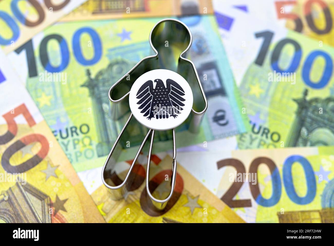 Figur mit Bundesadler auf Geldscheinen, Symbolfoto Bürgergeld Stock Photo