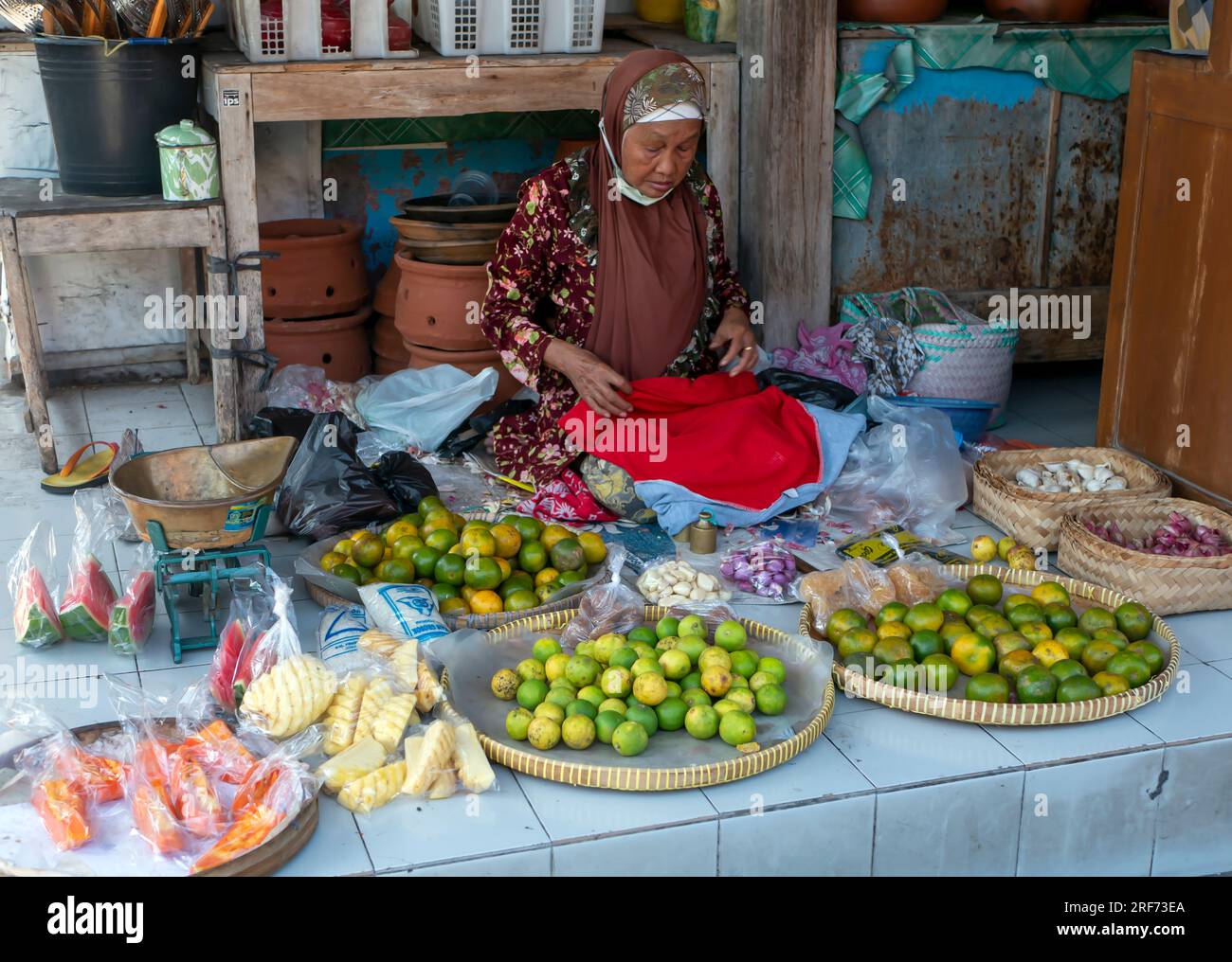 Yogyakarta-Indonesia, July 19, 2023: An old Indonesian woman selling fruits at a traditional market in, Yogyakarta, Indonesia Stock Photo