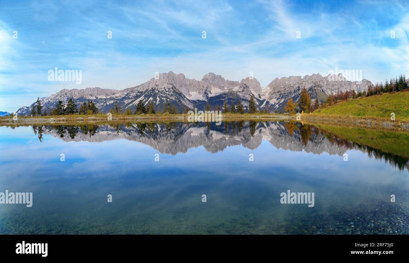Panoramic view of Wilder Kaiser mountain ridge with reflection on the Astbergsee lake, Tirol, Austria Stock Photo