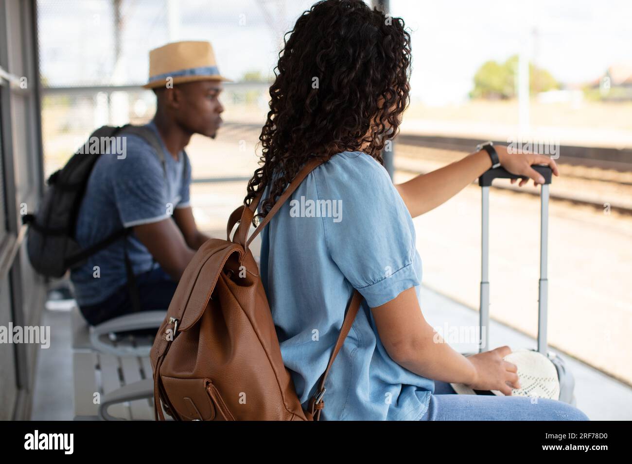 two people waiting for transport Stock Photo - Alamy