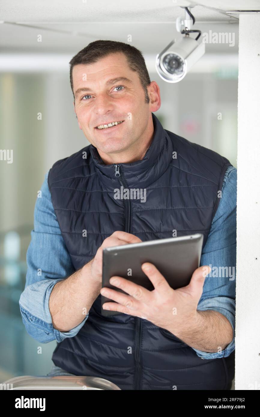 professional cctv technician working with tablet Stock Photo