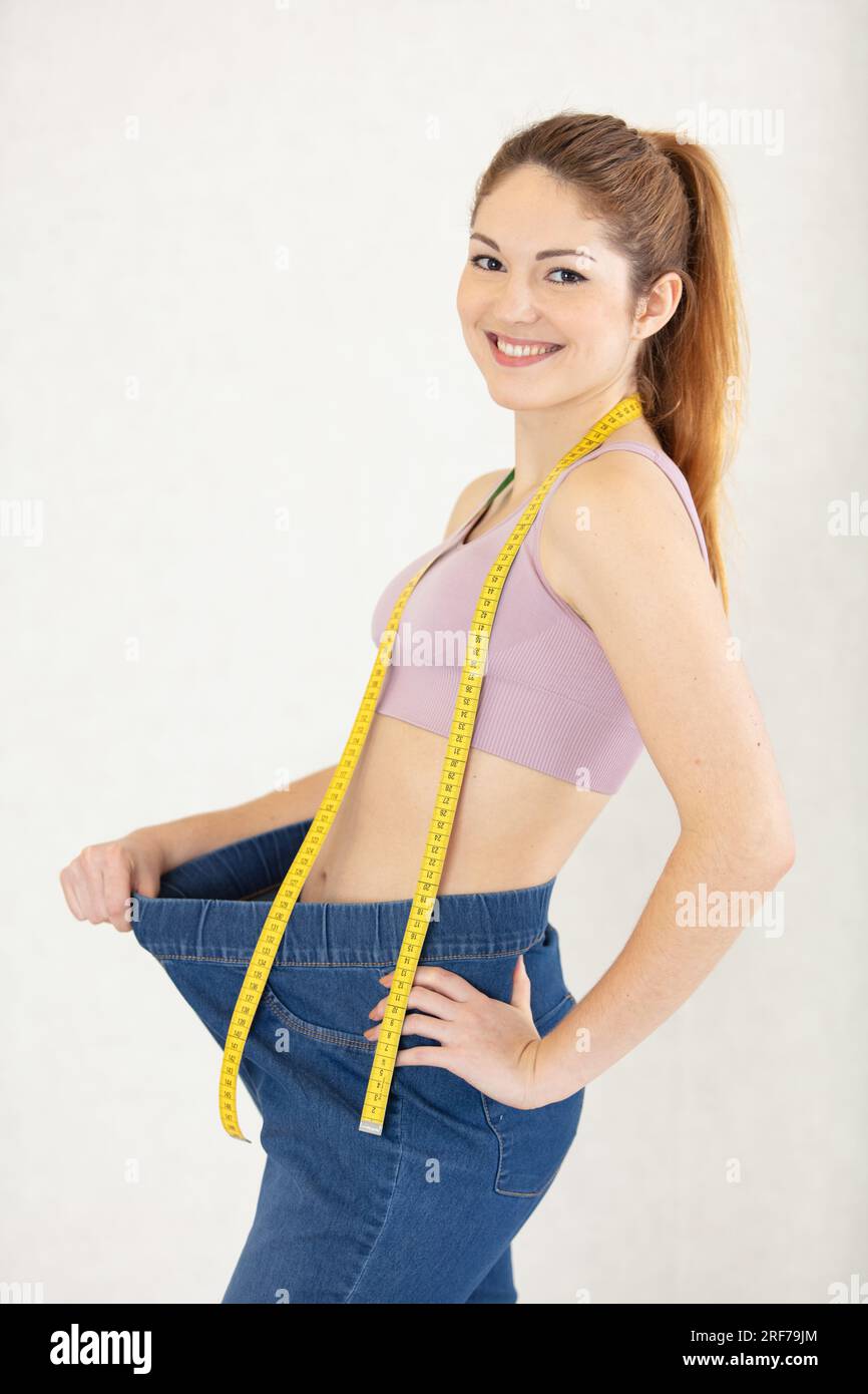 fit young woman with a measuring tape Stock Photo