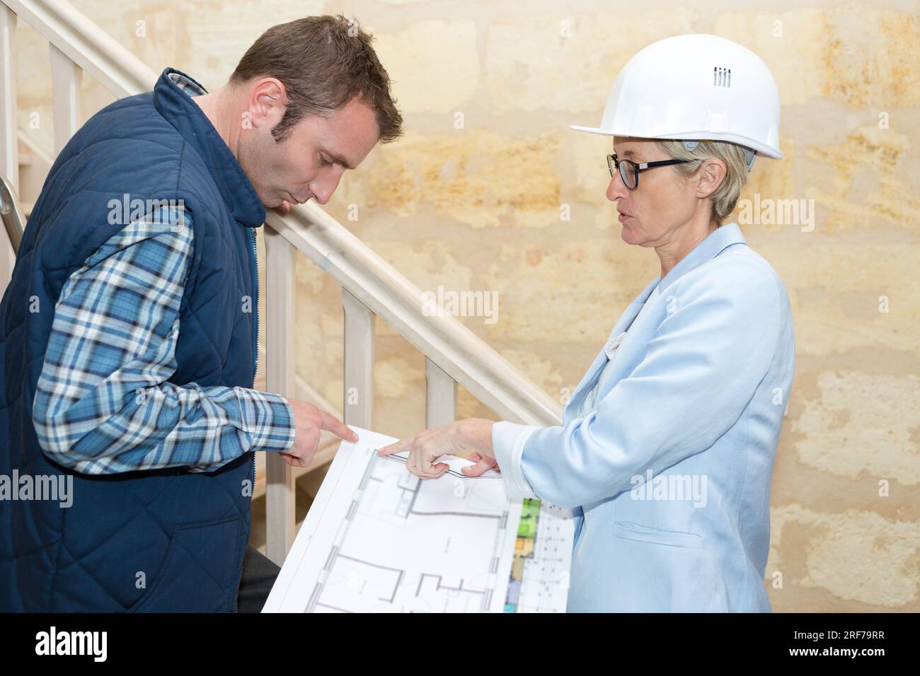 female architect talking to male builder Stock Photo
