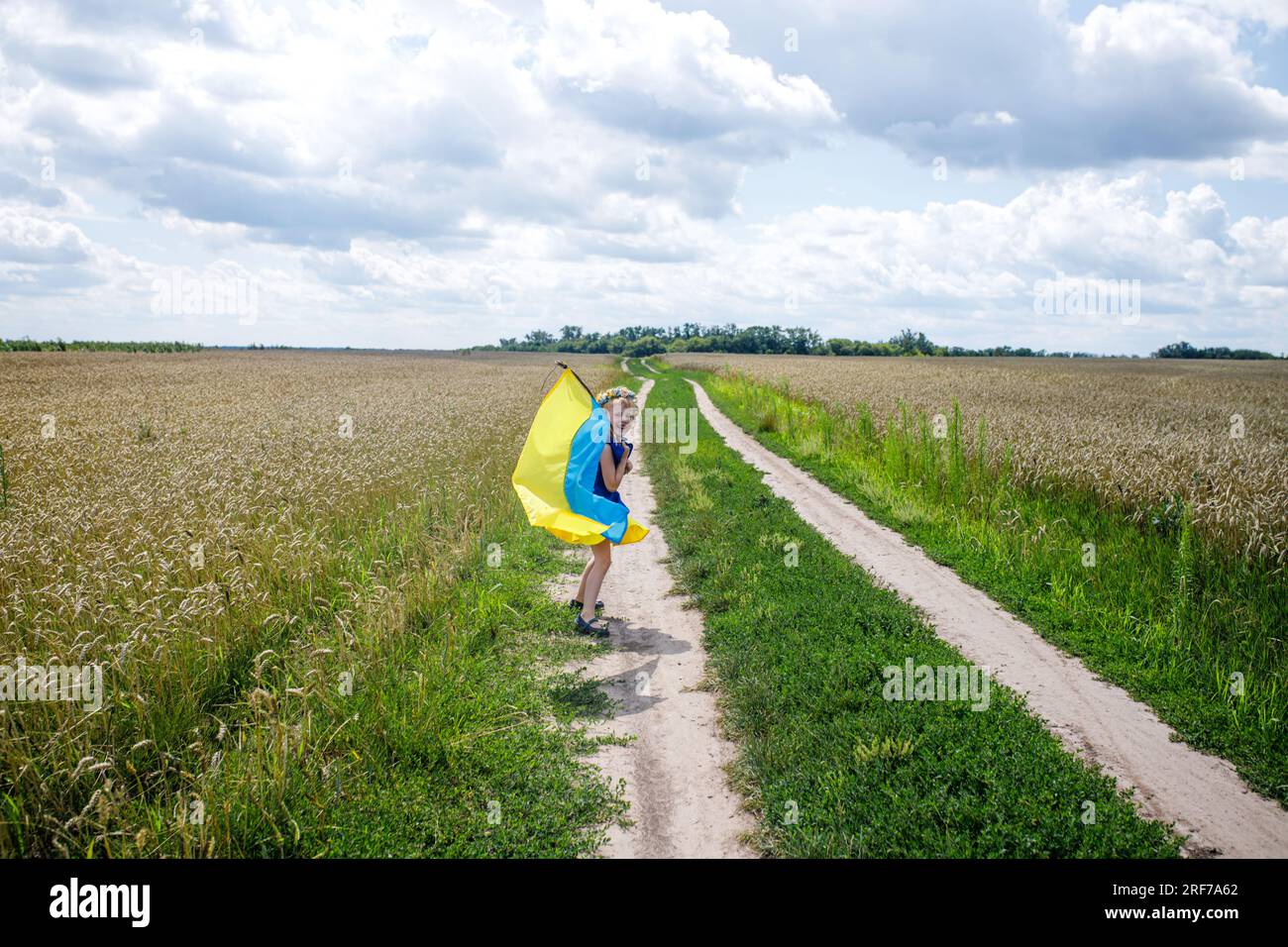 Ukraine's Independence Day. Little girl wrapped in flag of Ukraine