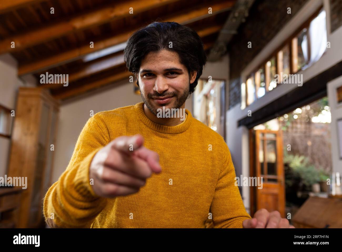 Happy indian man making video call at sunny home Stock Photo