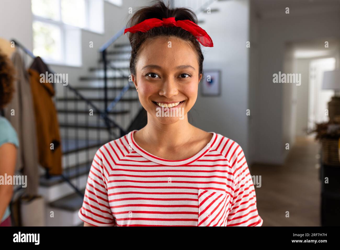 Portrait of happy asian woman with red band on head at home Stock Photo