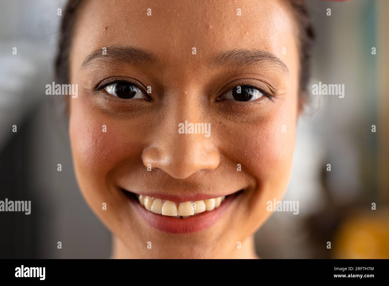 Portrait of happy asian woman with tied hair at home Stock Photo