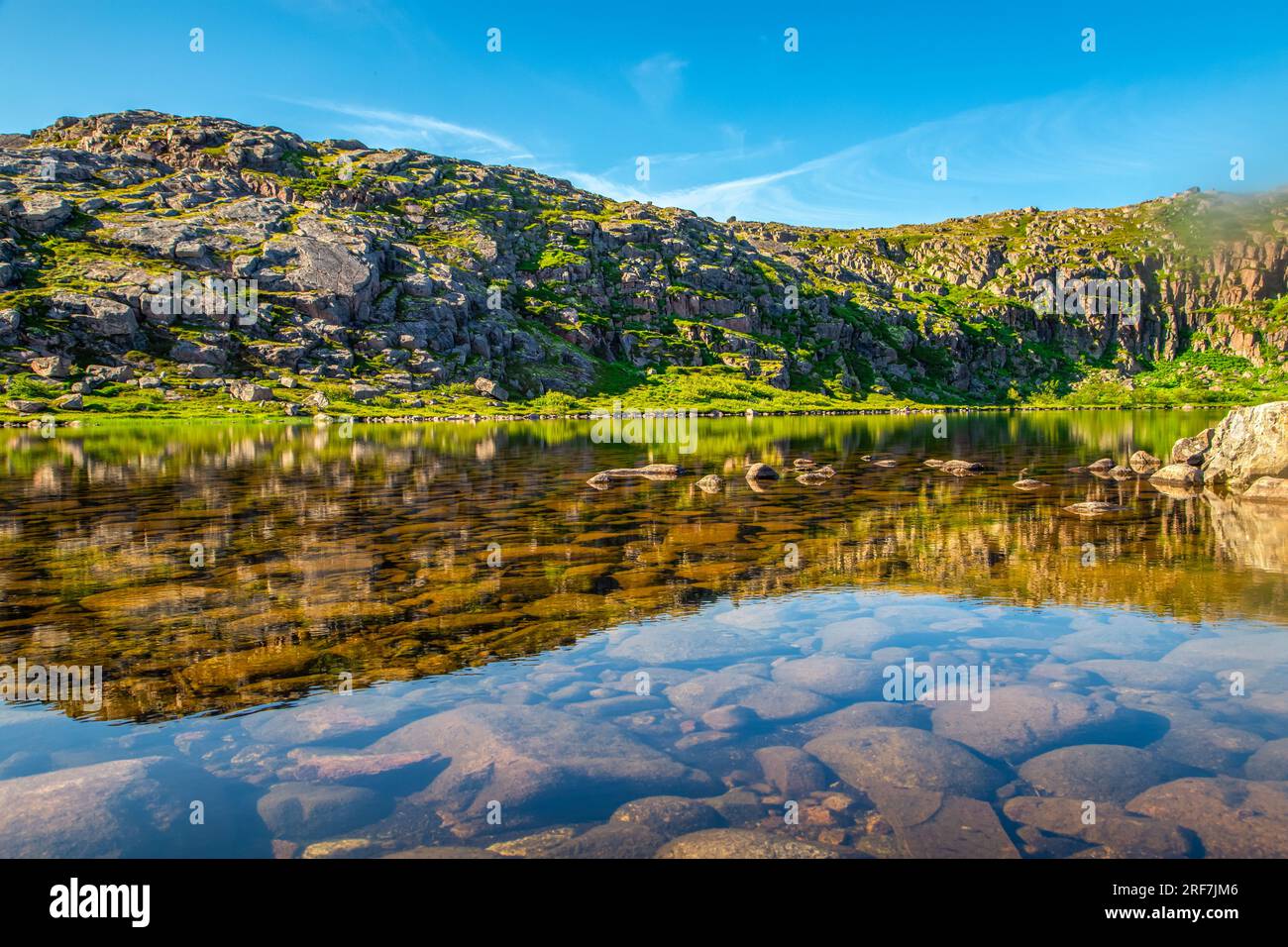 Picturesque lake near the Barents sea. Tundra in summer. Neighborhood of Teriberka village. Stock Photo