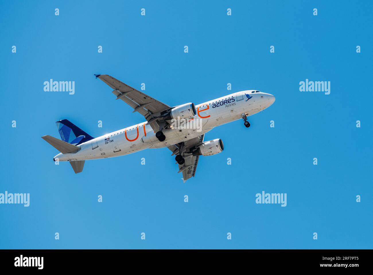 Portuguese air company Air Azores with aircraft Airbus A321-253NX approaching to land at Lisbon International Airport against blue sky Stock Photo