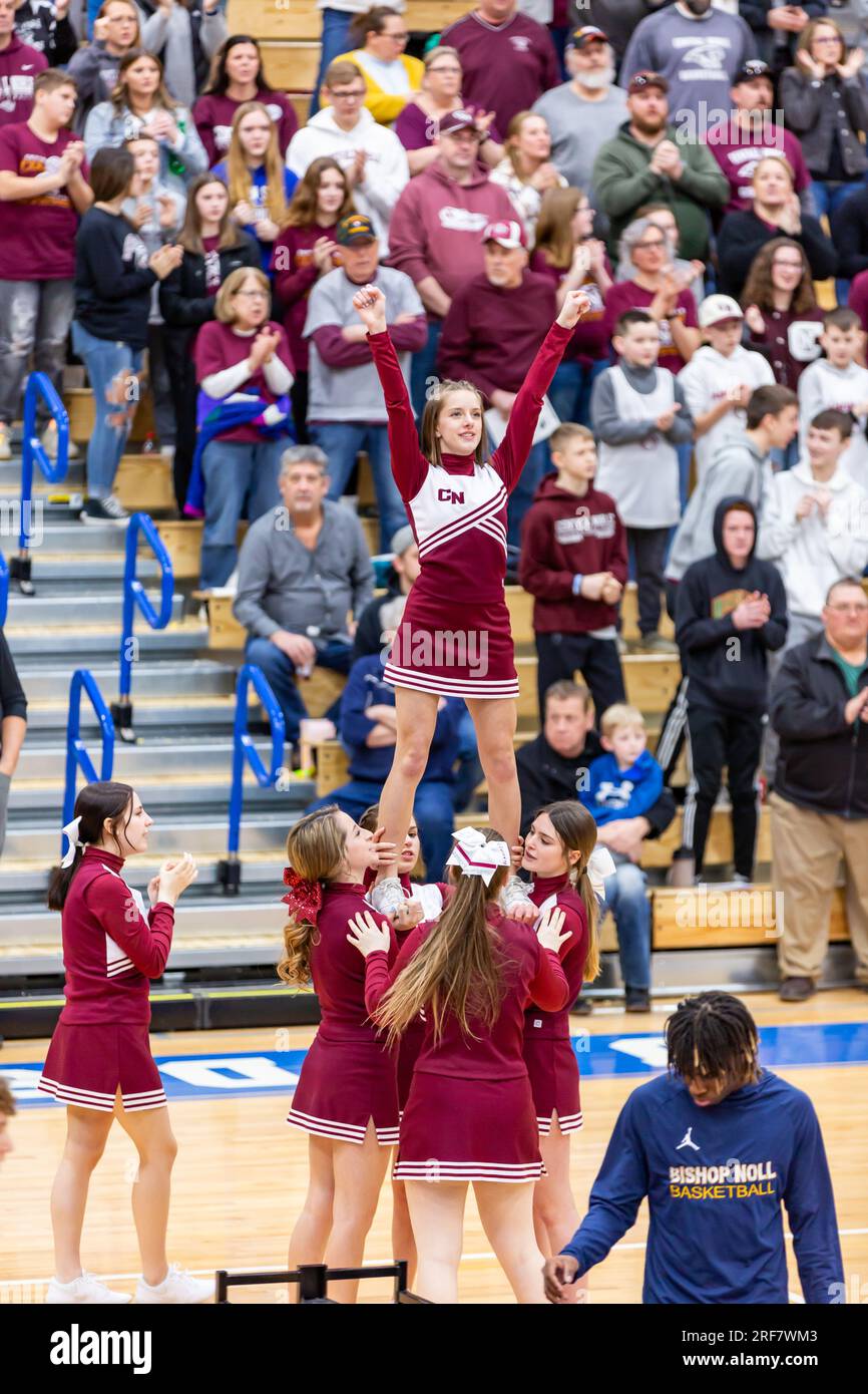 Central Noble High School cheerleaders perform in front of their fans during an IHSAA high school basketball game at North Judson, Indiana, USA. Stock Photo