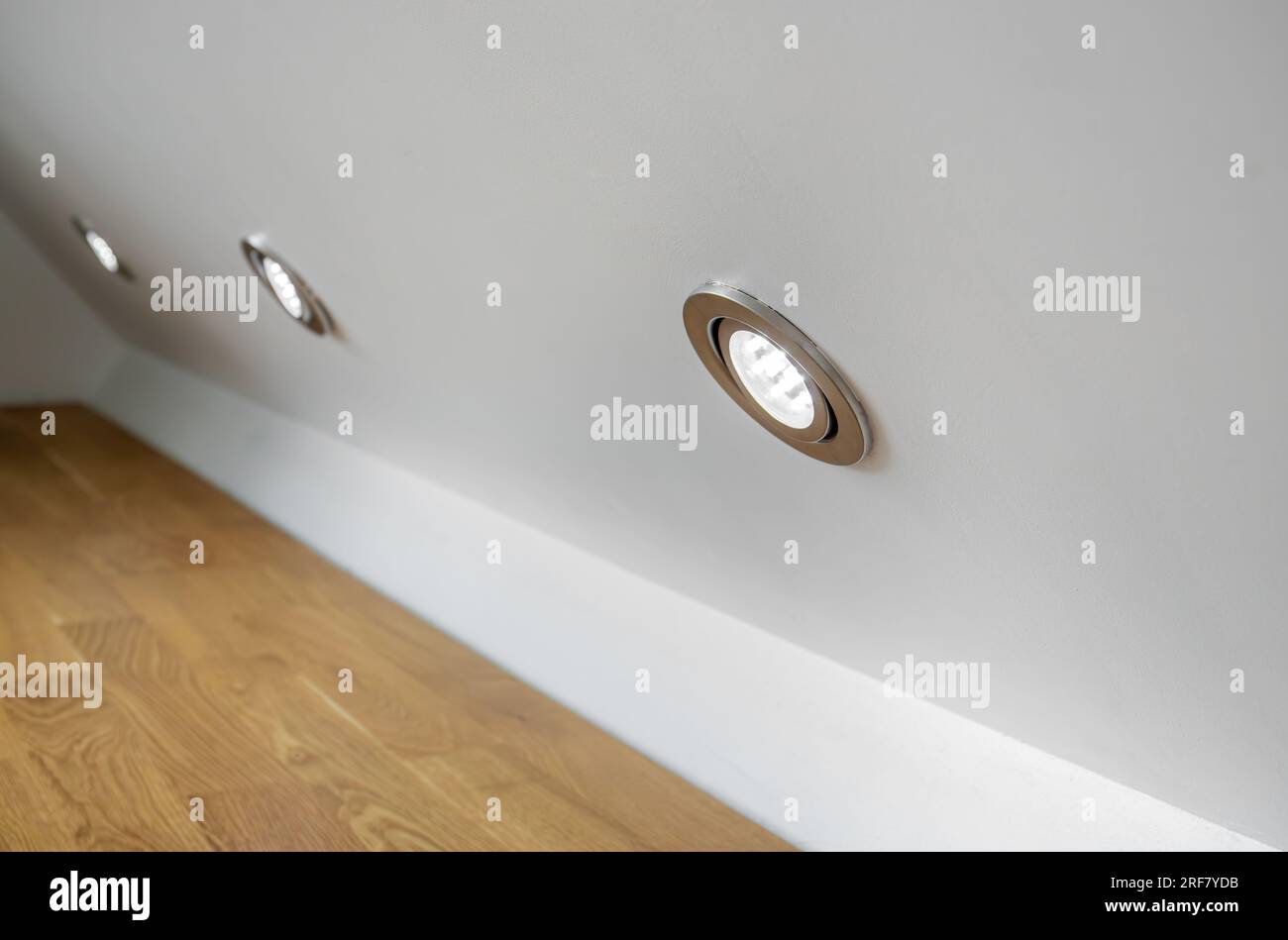 Built in small round LED down lights inside home room wall. Home decor concept. Stock Photo