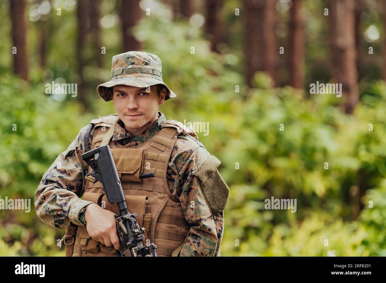 A modern warfare soldier on war duty in dense and dangerous forest ...