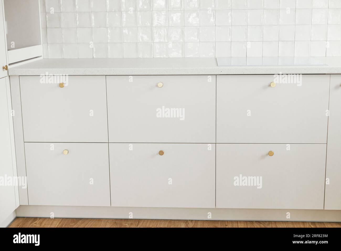 Modern kitchen interior. Stylish white kitchen cabinets with brass ...