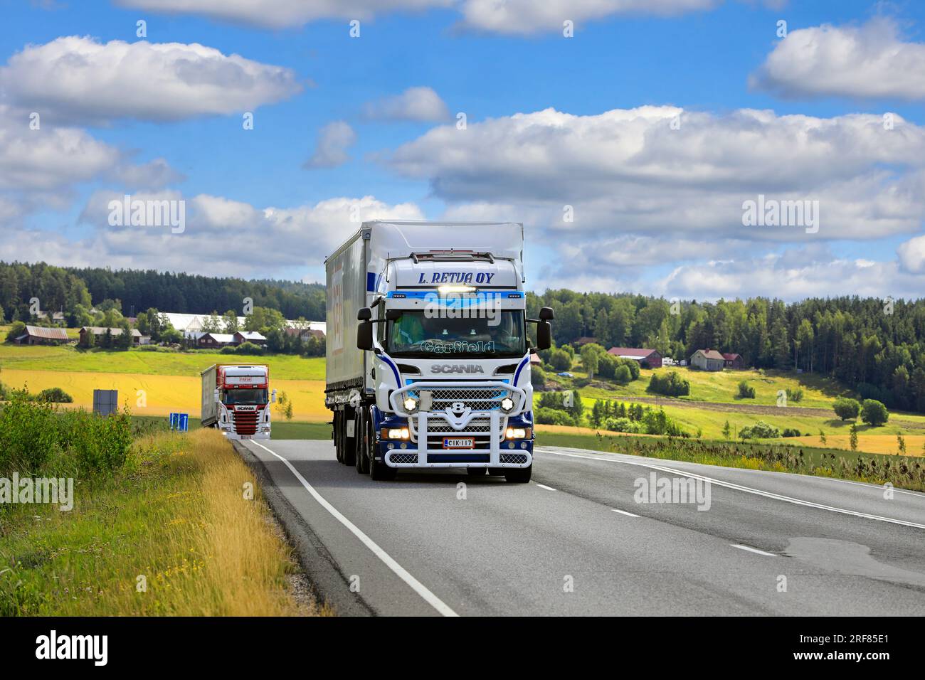 Customised Scania truck L Retva Oy pulls semi-trailer on road 110 on a day of summer, bright high beams on briefly. Salo, Finland. July 22, 2023. Stock Photo