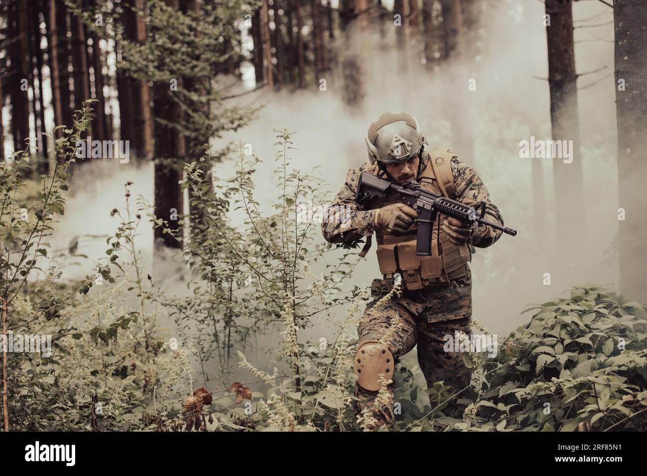 A modern warfare soldier on war duty in dense and dangerous forest ...