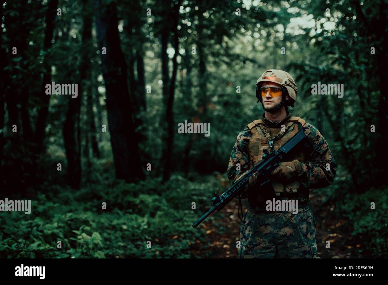 A modern warfare soldier on war duty in dense and dangerous forest ...