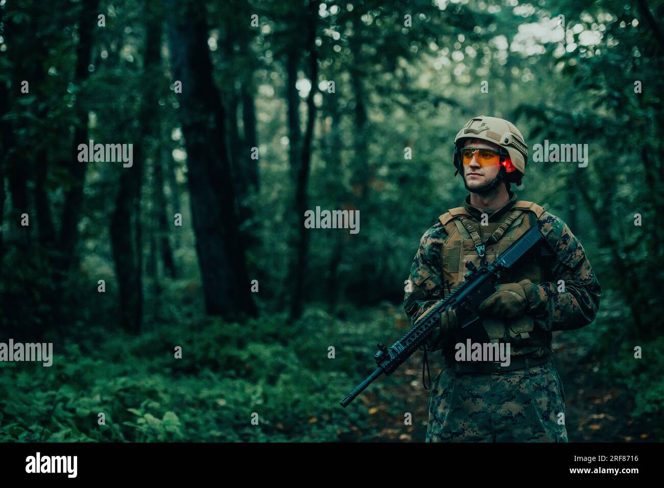 A modern warfare soldier on war duty in dense and dangerous forest ...