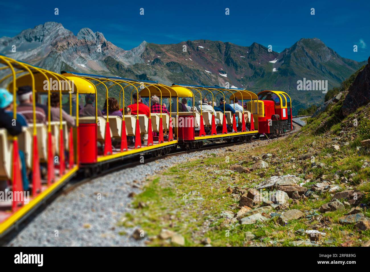 Mountains red train in Alps carries tourists Stock Photo