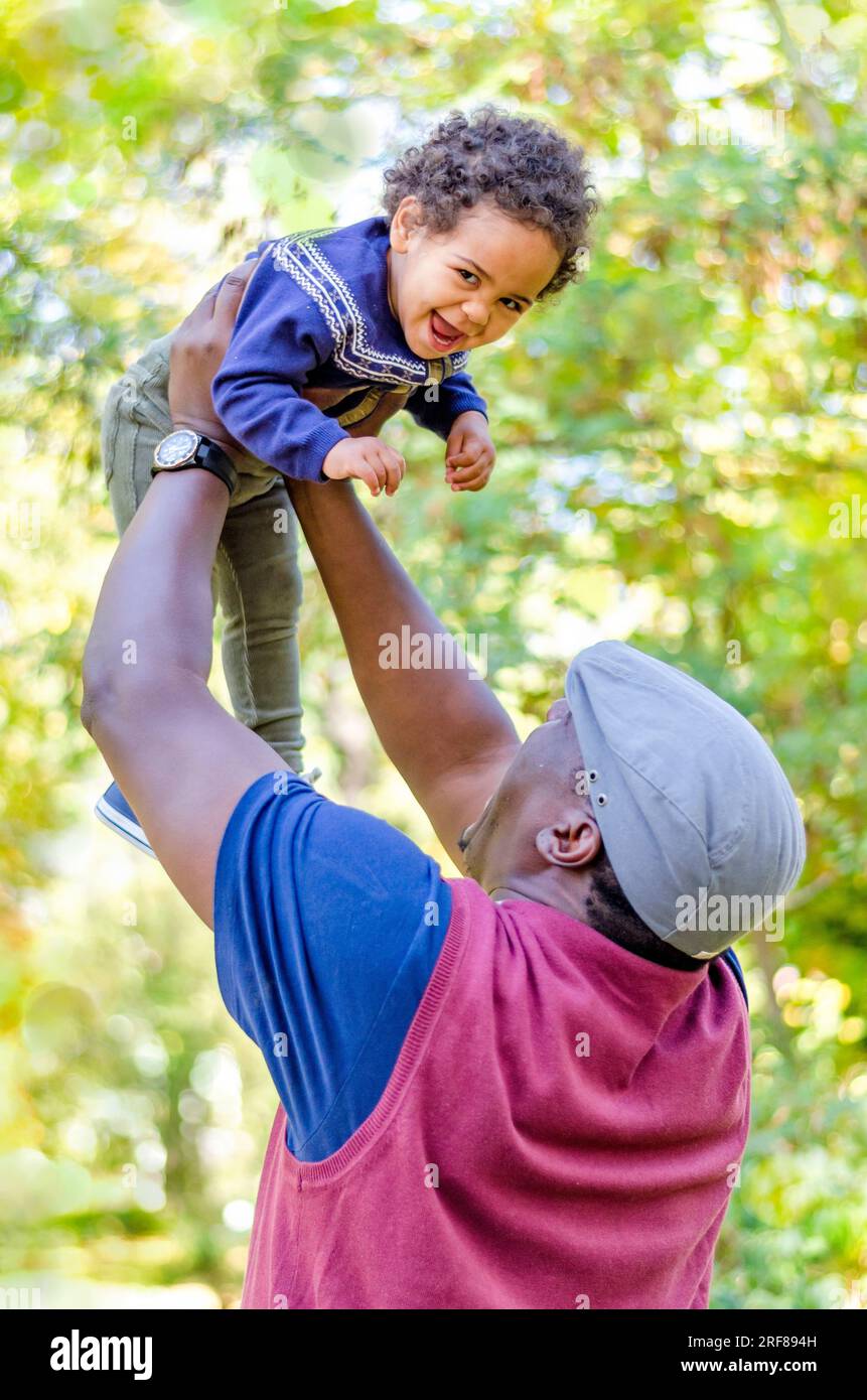 Happy mixed race family, happy dad holding his beautiful baby girl