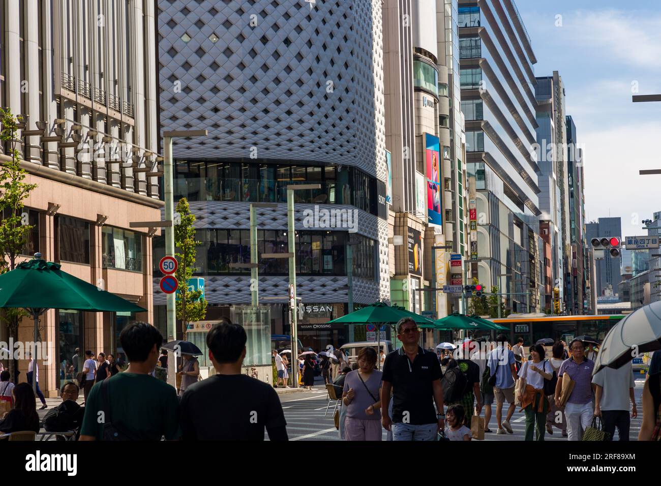 TOKYO, JAPAN - JULY 30 2023: Crowds of shoppers in the high-end luxury retail area of Ginza, central Tokyo Stock Photo
