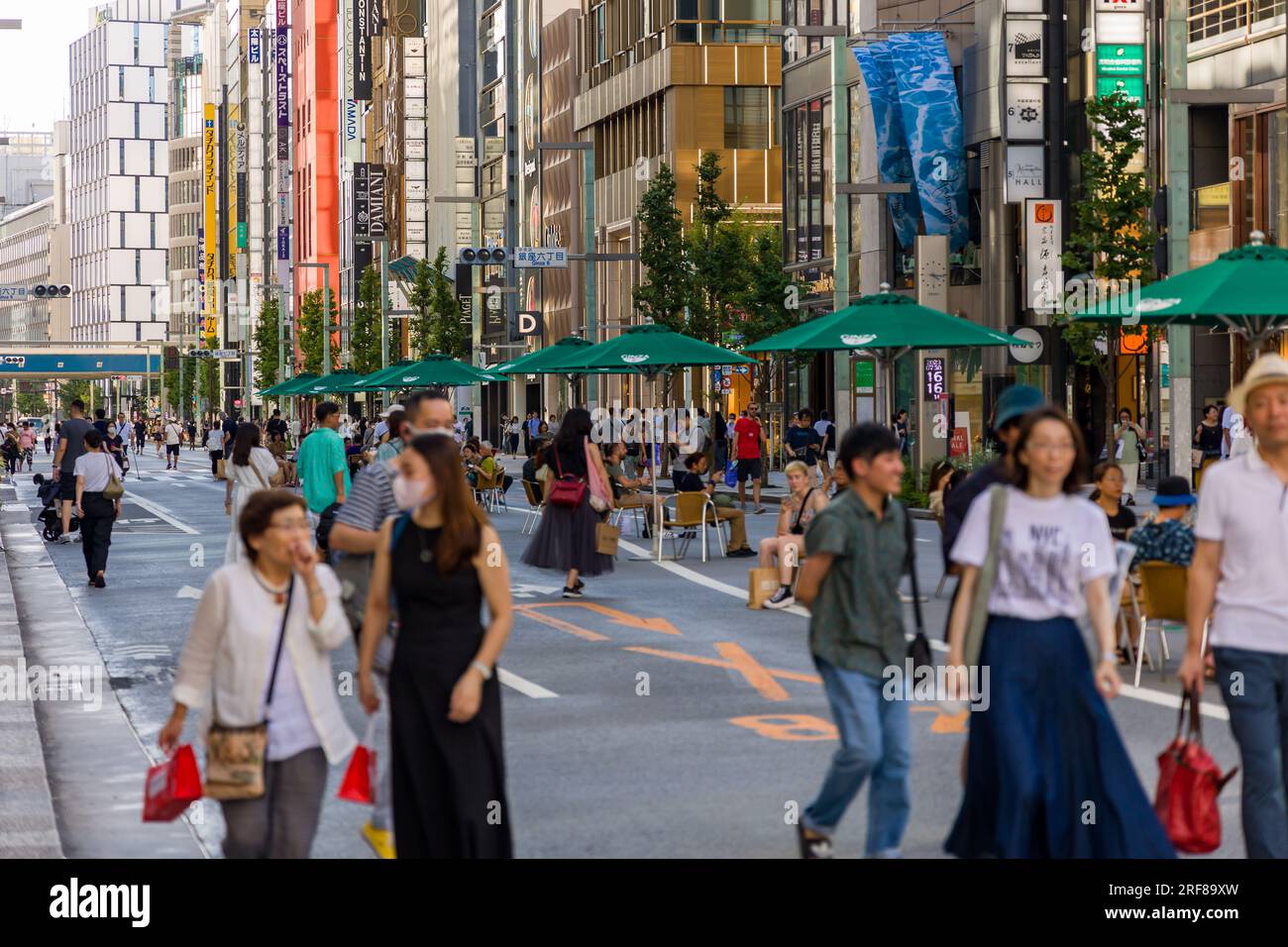 TOKYO, JAPAN - JULY 30 2023: Crowds of shoppers in the high-end luxury retail area of Ginza, central Tokyo Stock Photo