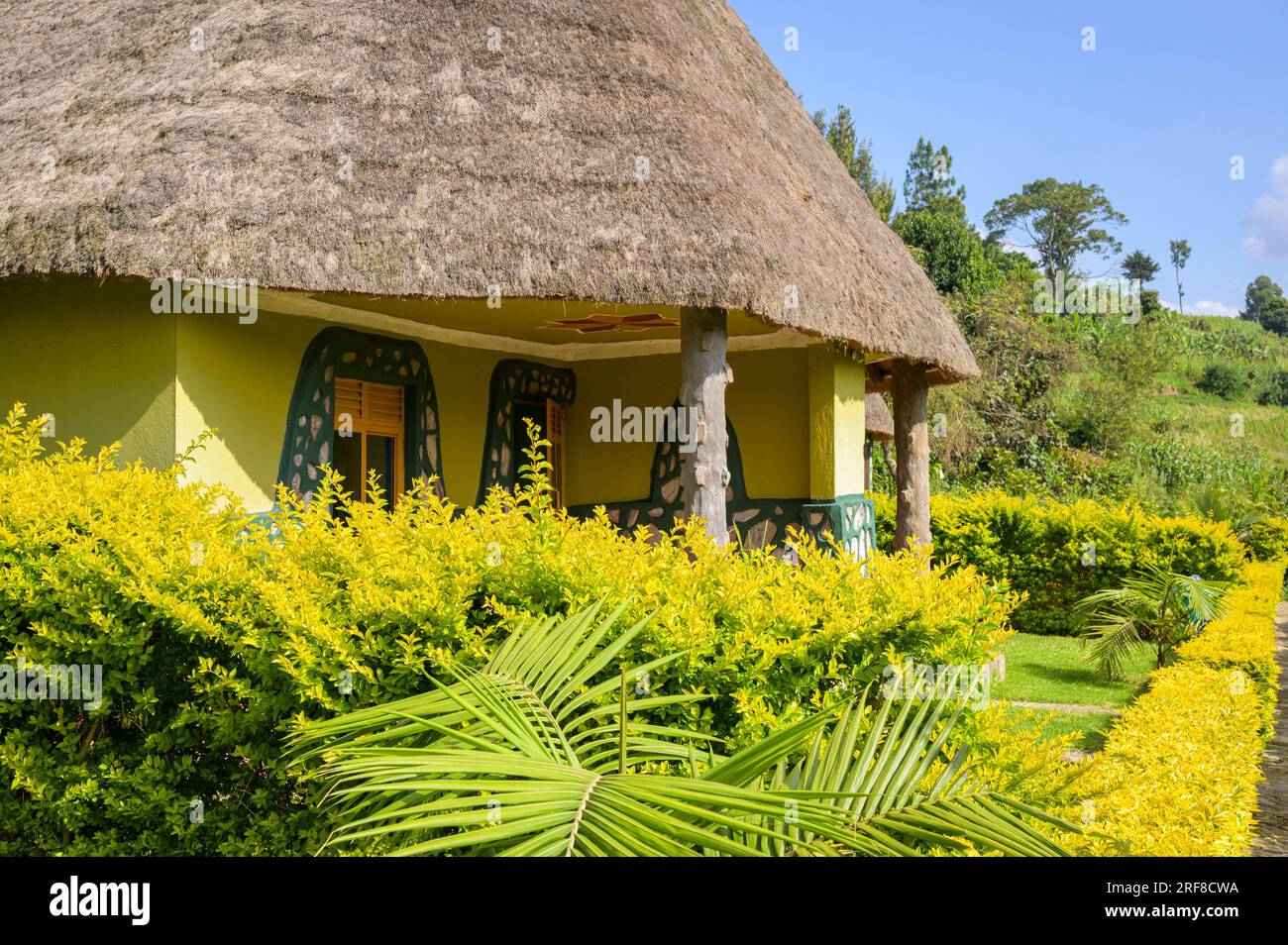 a traditional yellow bungalow with a reed roof in eastern africa Stock Photo
