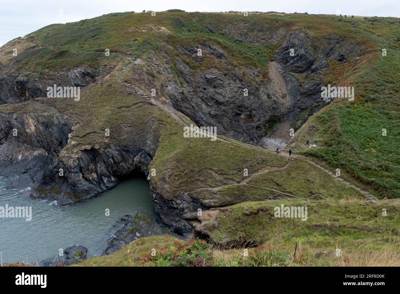 Witches Cauldron on 27th July 2023 in Moylgrove, Wales, United Kingdom. The Witches Cauldron is a collapsed cave which is fed by the tide and sometimes accessed by coasteering groups and wild swimmers. The Pembrokeshire coast encompasses dramatic natural scenery of cliffs, meadow and moor and offshore islands. The Pembrokeshire Coast Path follows the coastline of this designated a national park, the Pembrokeshire Coast National Park. Stock Photo