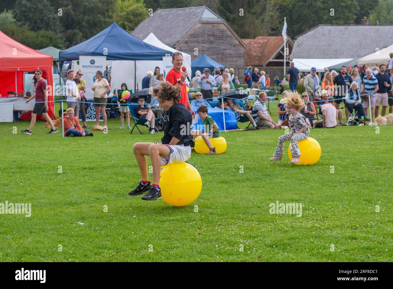 Space hopper racing racing at a country fair. Damerham, Hampshire, UK, August 2023 Stock Photo