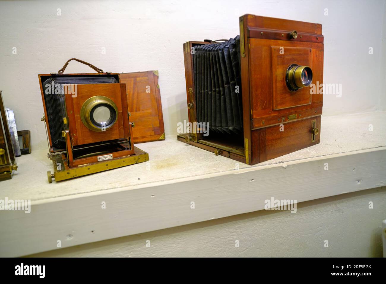 A very old camera on a shelf. Camera in working order. Assembled on a white wall shelf Stock Photo