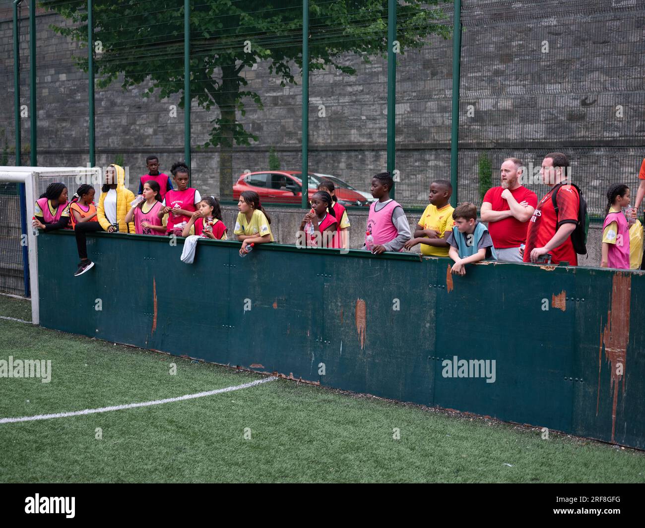Young people watching a football match in Dublin city, Ireland Stock