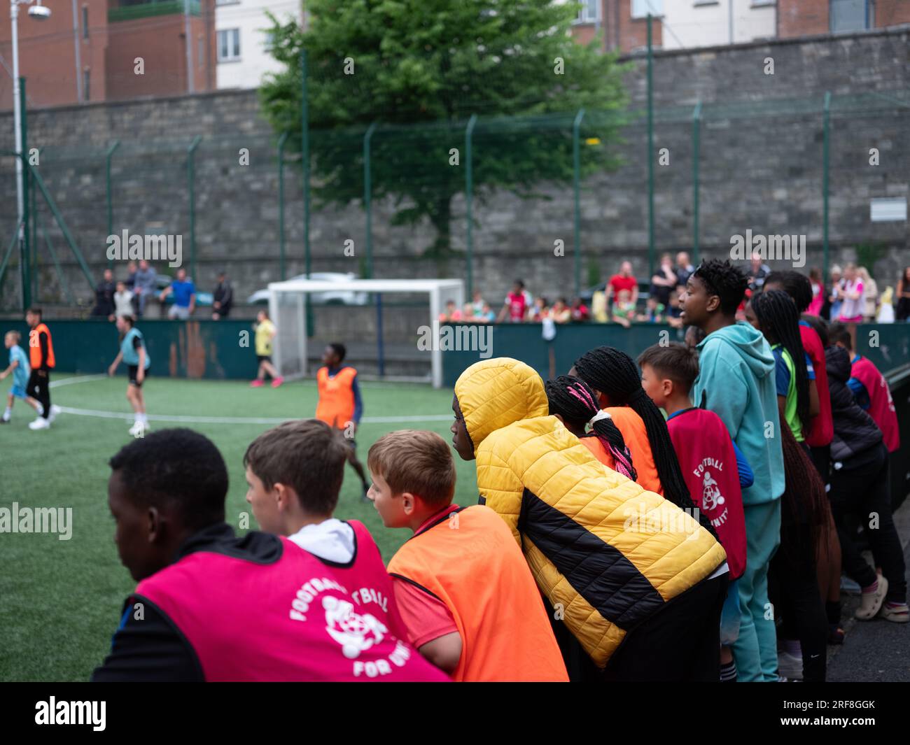 Young people watching a football match in Dublin city, Ireland Stock
