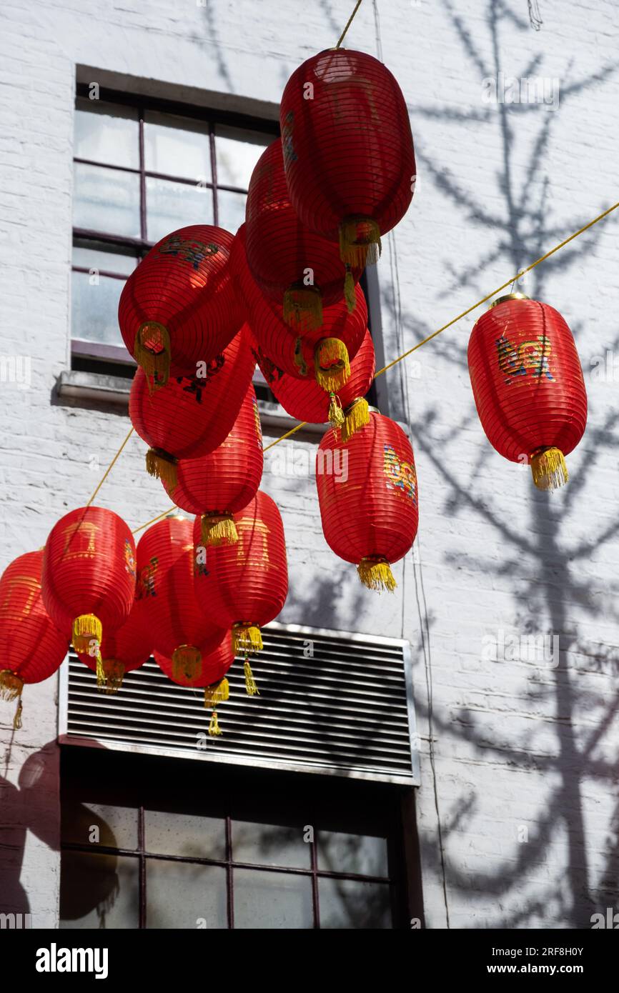 Chinese lanterns hang above a street in Chinatown, London, England. Stock Photo