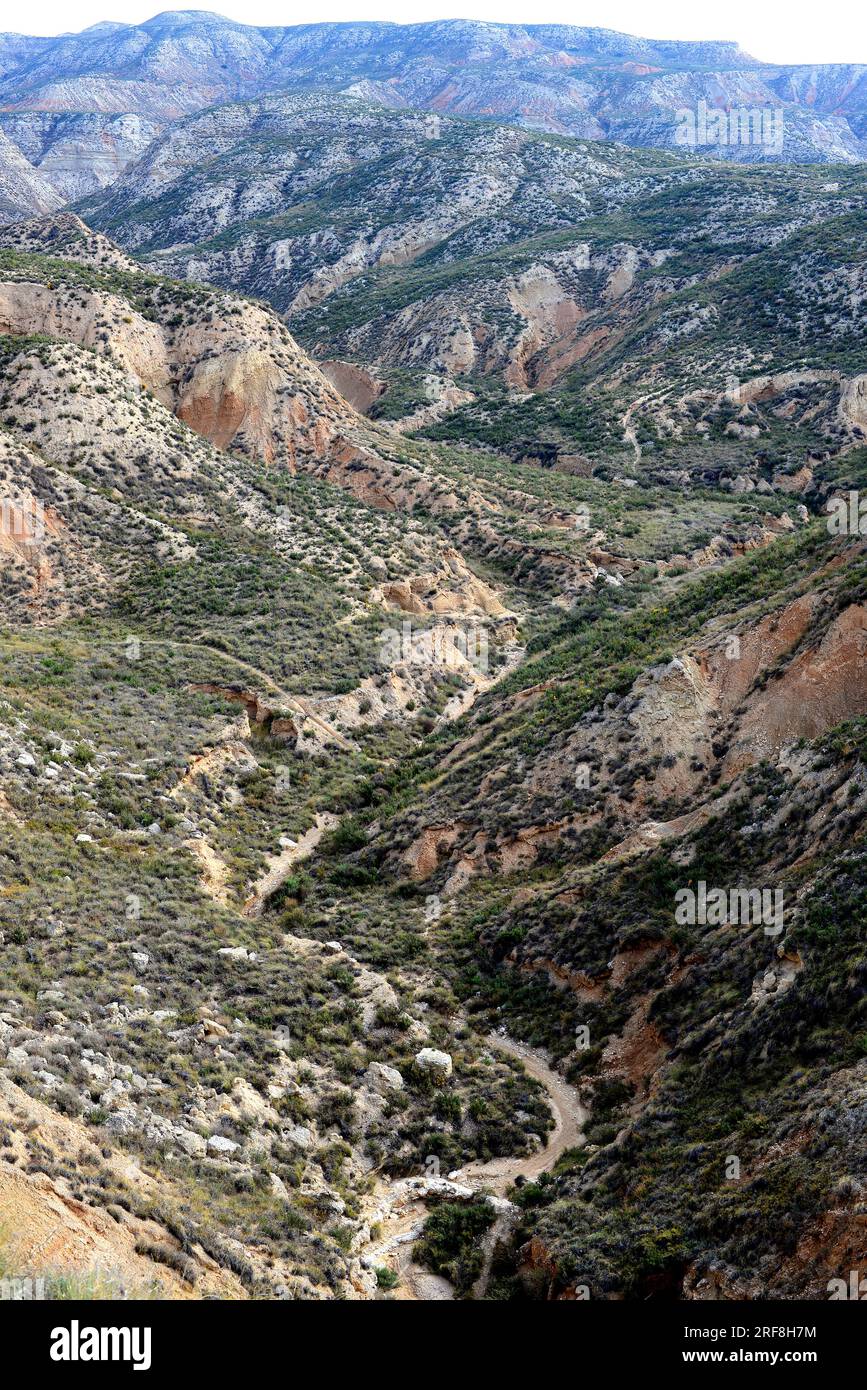 Arroyo or wash is a dry creek with temporarily flows after rains. This photo was taken in Remolinos, Zaragoza, Aragon, Spain. Stock Photo