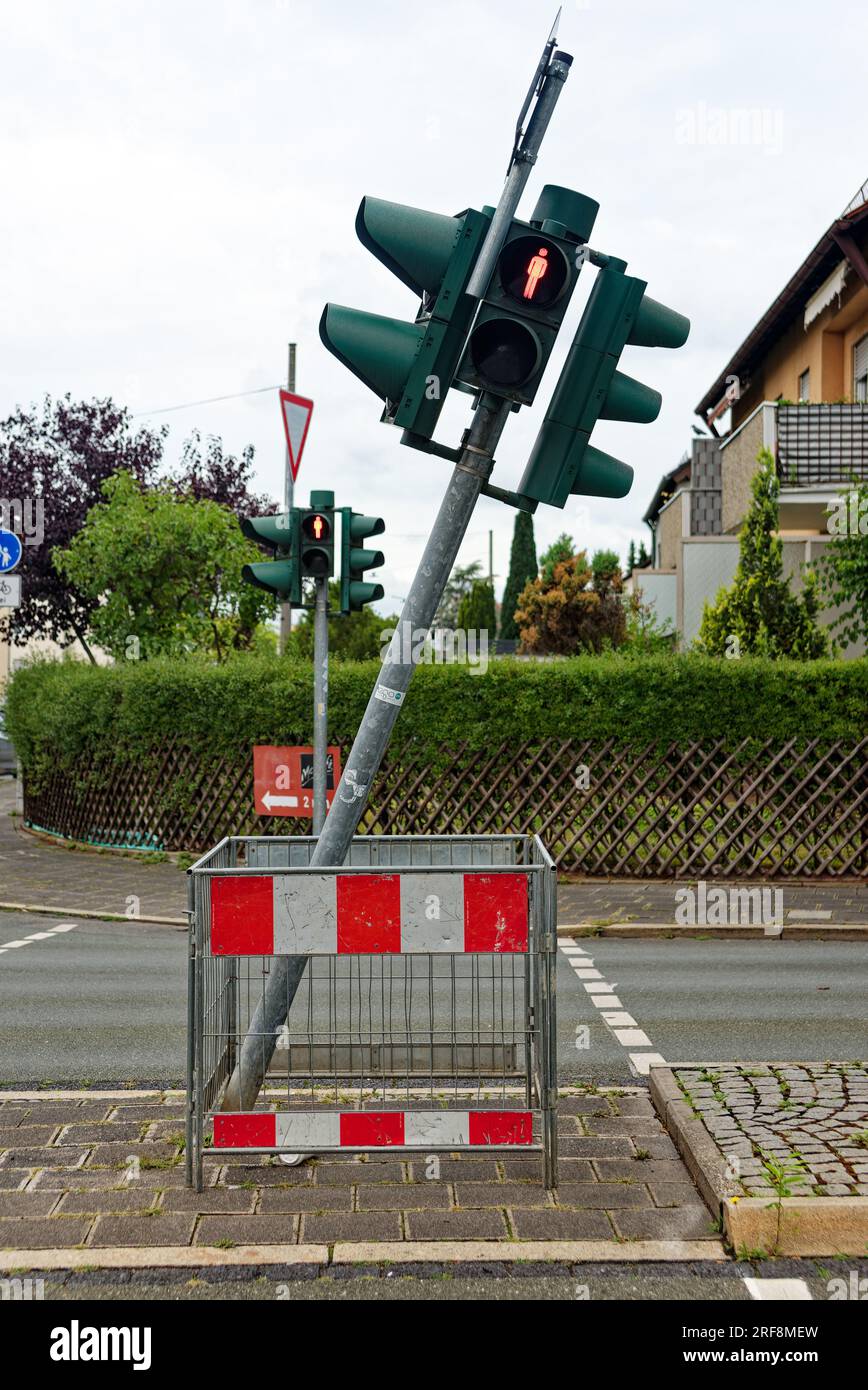 symbolic picture, traffic light out of balance; approached pedestrian traffic light is crooked Stock Photo