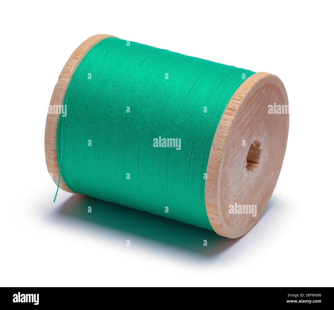 Spool of Green Thread Cut Out on White. Stock Photo