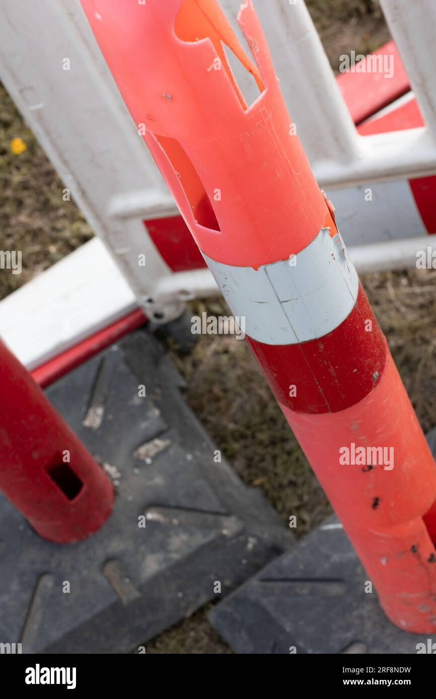 Used plastic roadwork markers at fiber connection digging site Stock