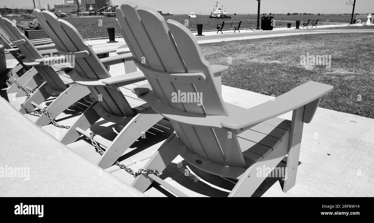Row of empty Adirondack chairs by the harbor shore Stock Photo Alamy