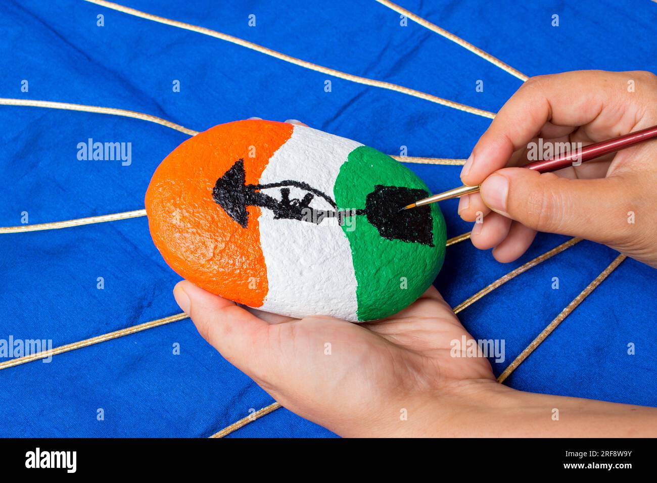 Hand painting stone with brush . Indian flag color with ' amar Jawan Jyoti ' symbol . Stock Photo