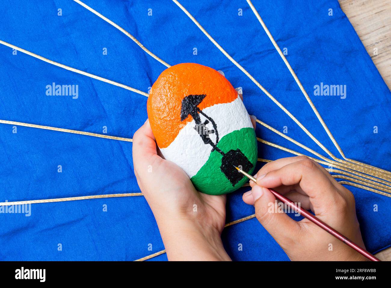 Hand painting stone with brush . Indian flag color with ' amar Jawan Jyoti ' symbol . Stock Photo