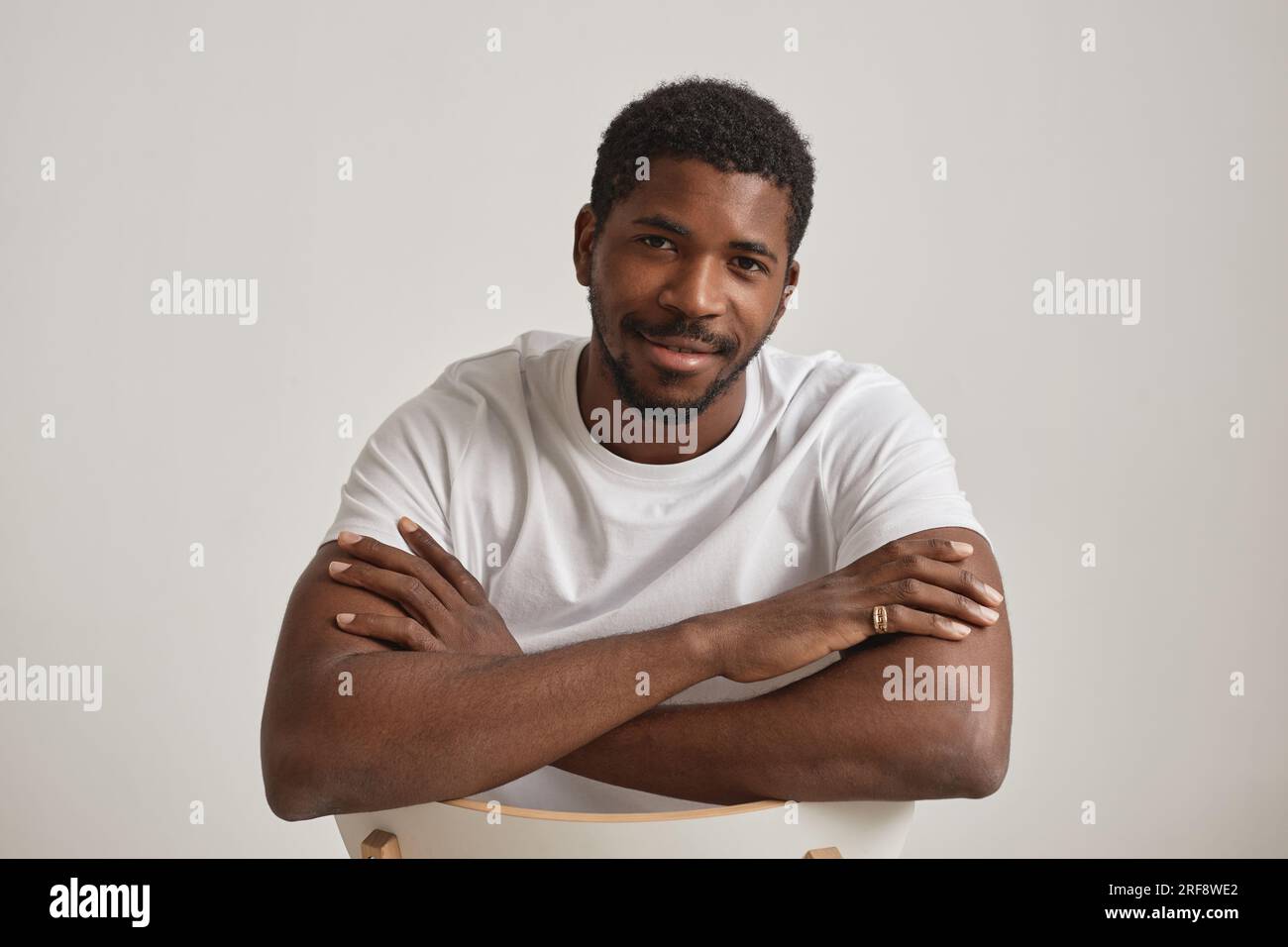 Minimal portrait of handsome black man in studio against white background Stock Photo