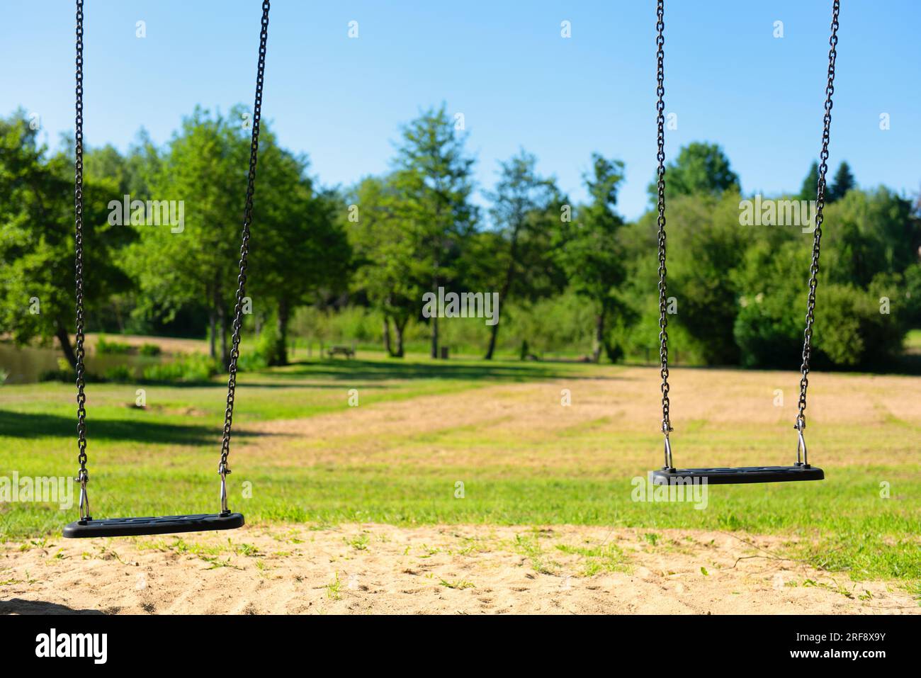 Empty swings in landscape in France Stock Photo Alamy