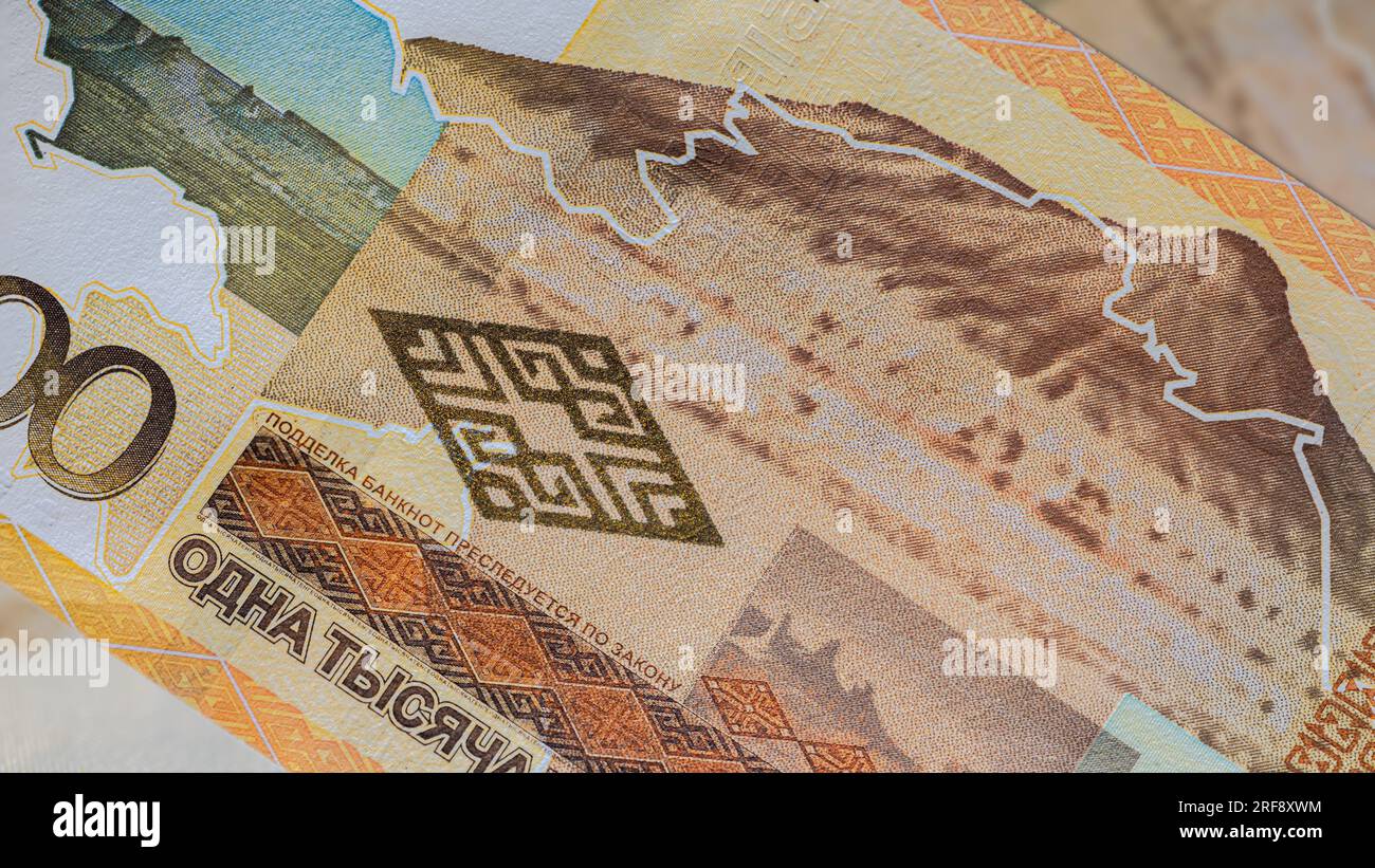 Close up to thousand Tenge of the Republic Kazakhstan. Paper banknotes of the Asian country. Detailed capture of the front art design. Detailed money. Stock Photo