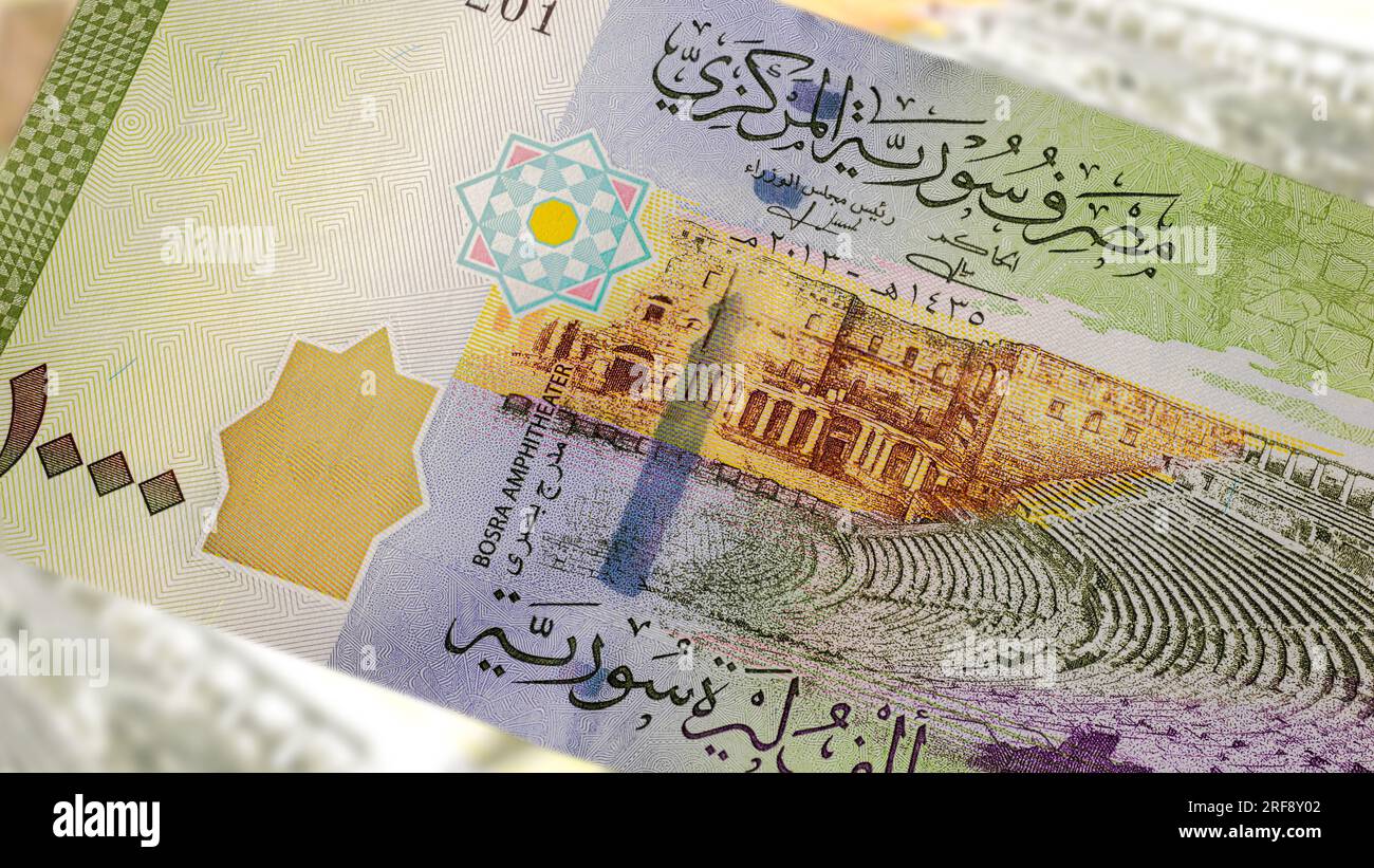 A close-up of a Syrian 1000 Pound banknote reveals intricate art and design. Amidst the country's turmoil, it showcases historical landmarks, symboliz Stock Photo