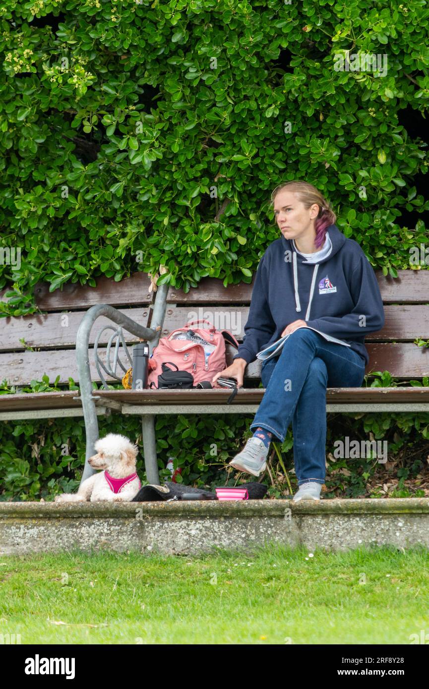 Lady sitting on bench with dog hi-res stock photography and images - Alamy