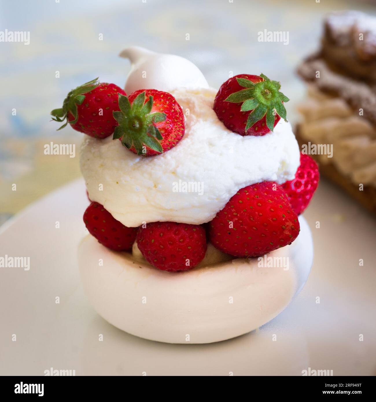 Individual strawberry Pavlova on a white plate Stock Photo
