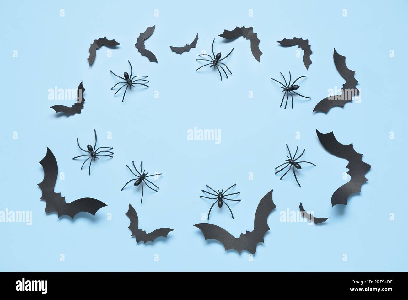Frame made of paper bats and spiders for Halloween party on blue ...