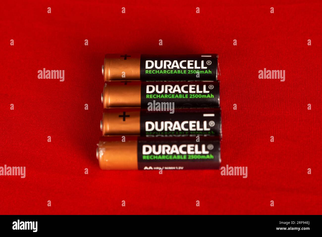 Salvador, Bahia, Brazil - July 30, 2023: Four Duracell brand rechargeable batteries isolated on red background. Stock Photo