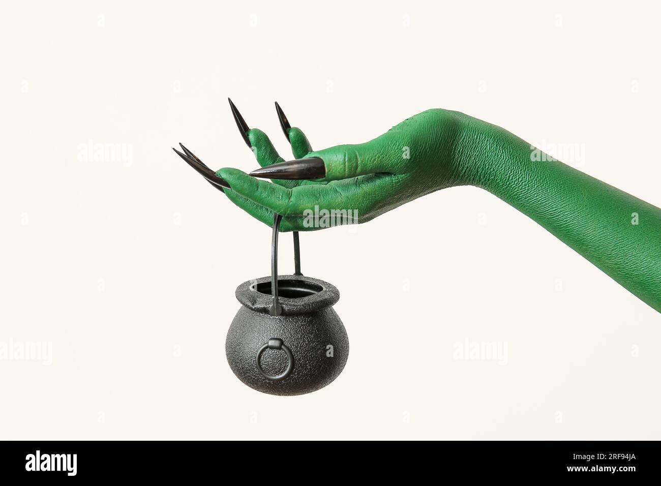 Hand of witch with cauldron on white background. Halloween celebration ...